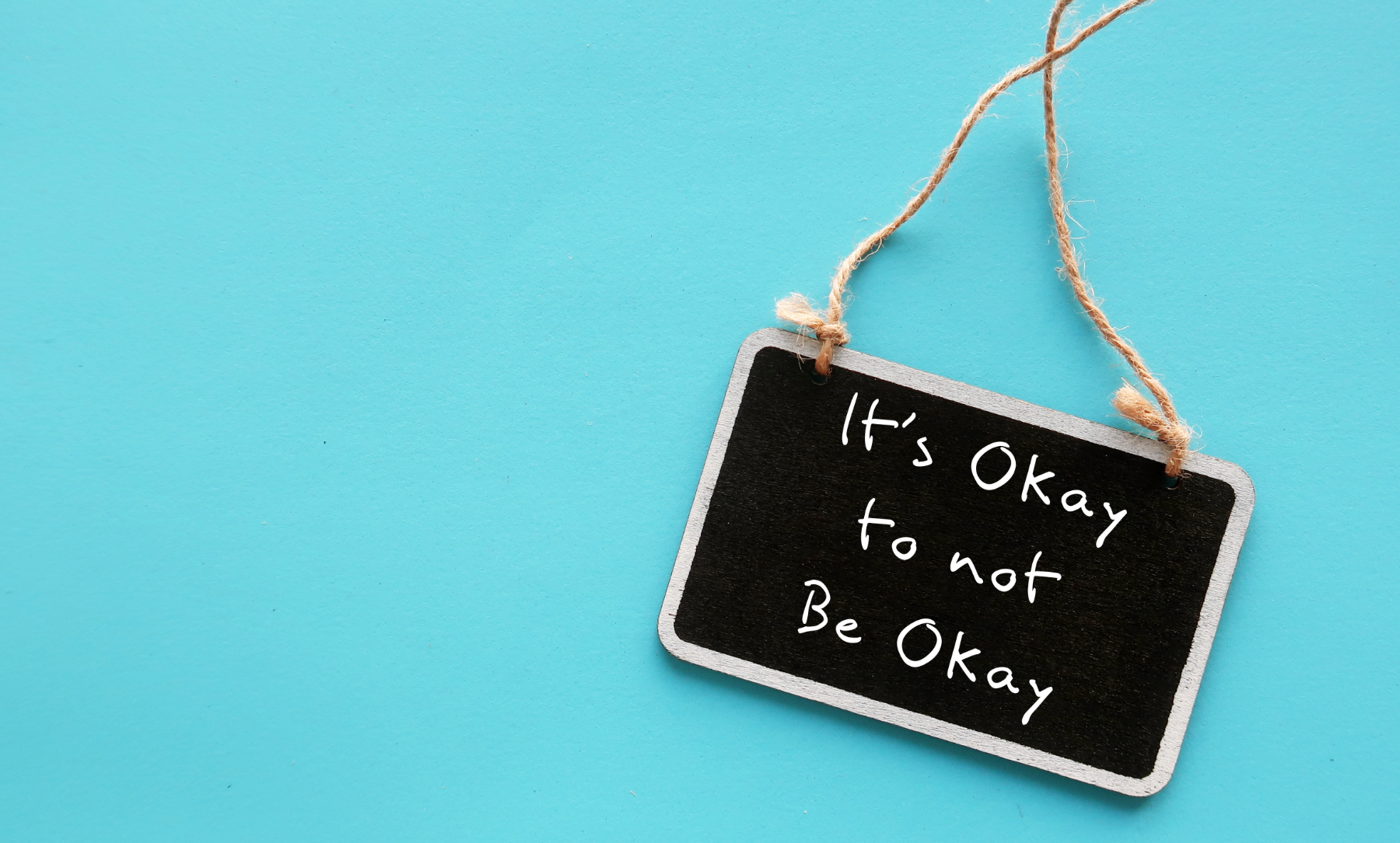 A mini chalk board with the text it is ok to not be ok